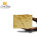 Canteras Naturales Santo Tomás Cantera Oro stone tile with a warm golden ochre hue and a rough, wavy artisanal texture