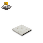 Canteras Naturales Santo Tomás white Mexican stone tile with natural green, grey, and black mineral inclusions.