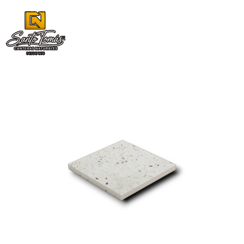 Canteras Naturales Santo Tomás white Mexican stone tile with natural green, grey, and black mineral inclusions.
