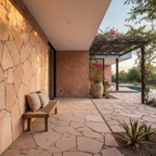 Fachada y piso exterior con piedra laja salmón irregular de acabado rústico en una terraza moderna con alberca.